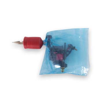 Tattoo machine inside transparent blue Killer Ink bag without elastic, open box view.