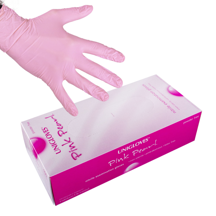Box of 100 Unigloves Pink Pearl nitrile examination gloves with a pink glove worn on hand.